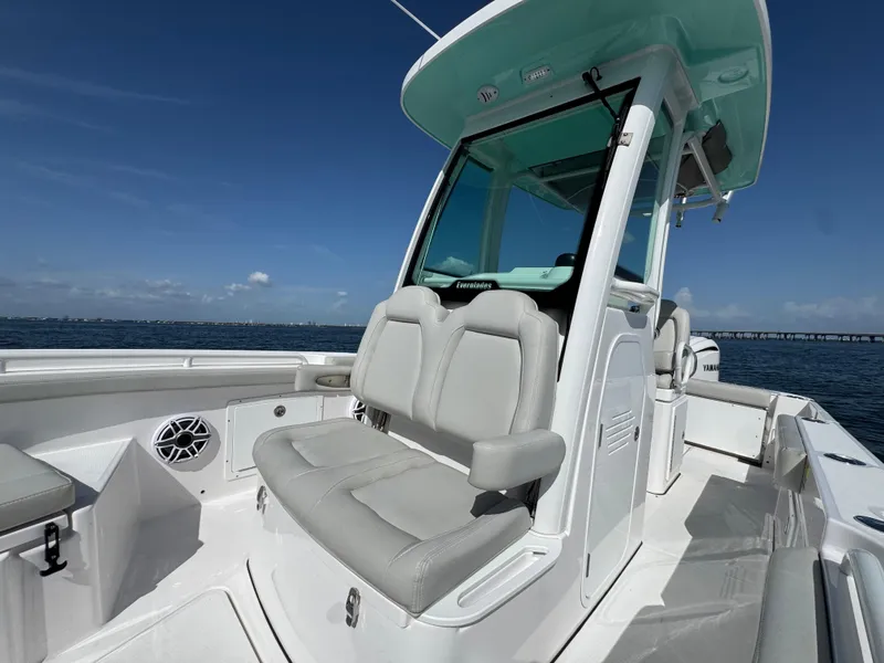 Slide: The Image of 2022 Everglades 235 Center Console boat with seating, on open water under clear skies. - 16