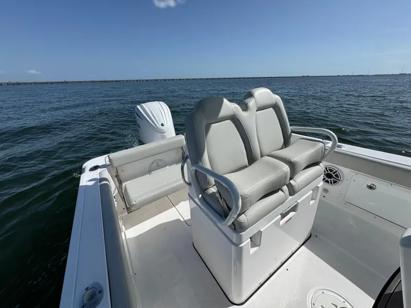 Slide: The Image of 2022 Everglades 235 Center Console boat on open water, featuring comfortable seating. - 20