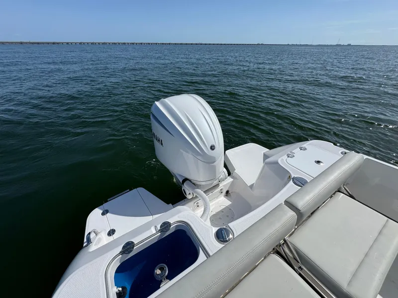 Slide: The Image of 2022 Everglades 235 Center Console boat on open water, featuring a powerful outboard motor. - 23