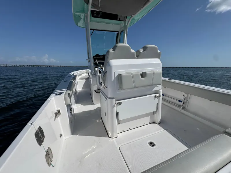 Slide: The Image of 2022 Everglades 235 Center Console boat on open water, clear sky. - 25