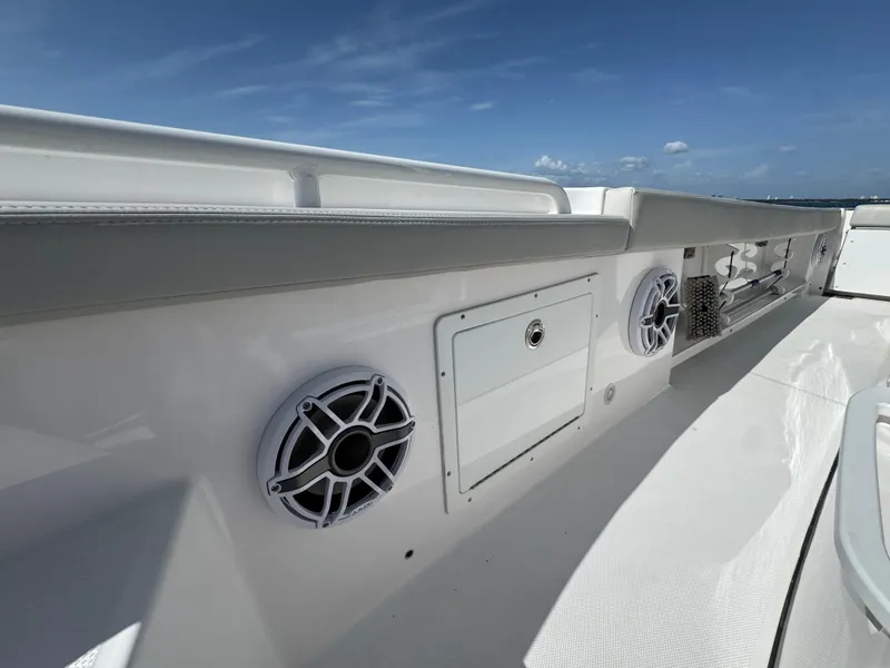 Slide: The Image of 2022 Everglades 235 Center Console boat deck with speakers and storage compartment. - 27