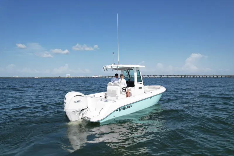 Slide: The Image of 2022 Everglades 235 Center Console boat cruising on open water under clear blue sky. - 3
