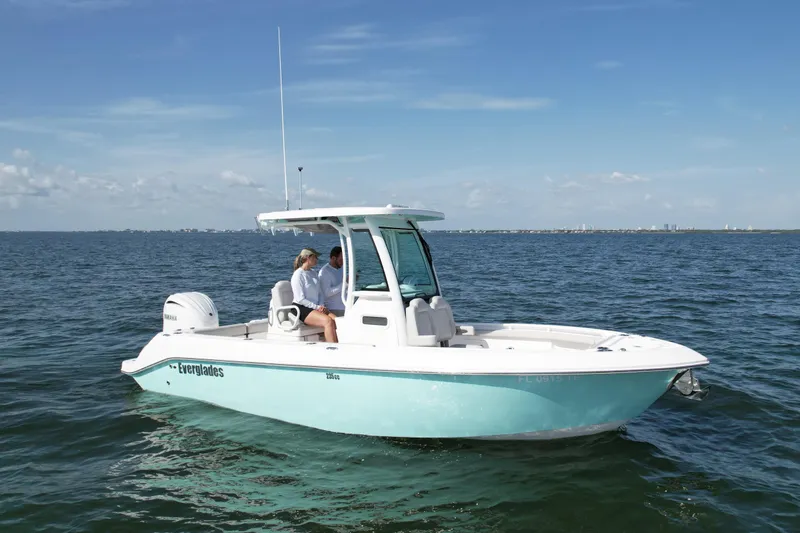Slide: The Image of 2022 Everglades 235 Center Console boat on open water under clear blue sky. - 4
