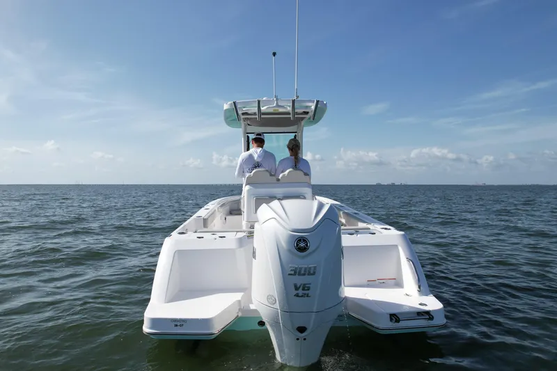 Slide: The Image of 2022 Everglades 235 Center Console boat on open water, rear view, clear sky. - 5
