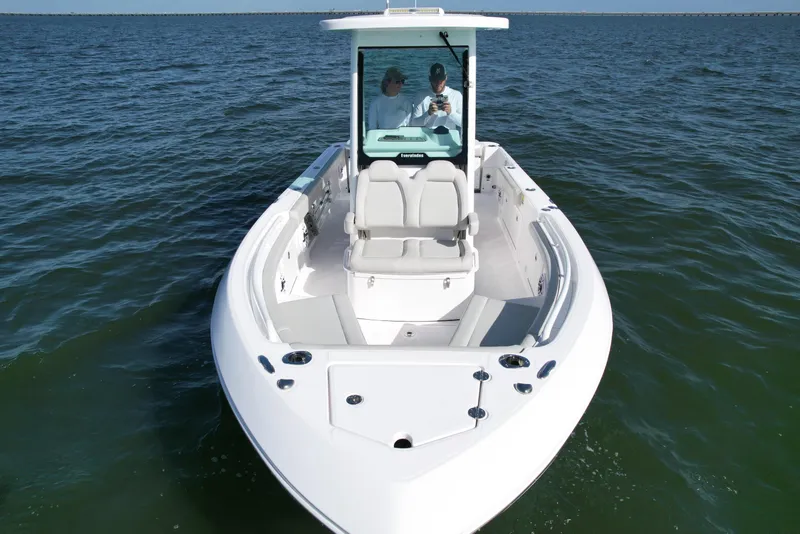 Slide: The Image of 2022 Everglades 235 Center Console boat on open water, front view. - 6