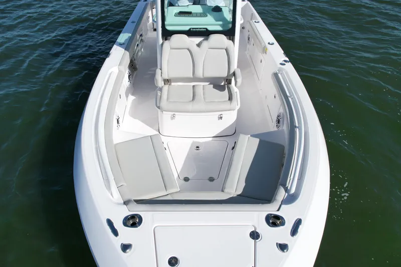 Slide: The Image of 2022 Everglades 235 Center Console boat with spacious seating on calm water. - 7