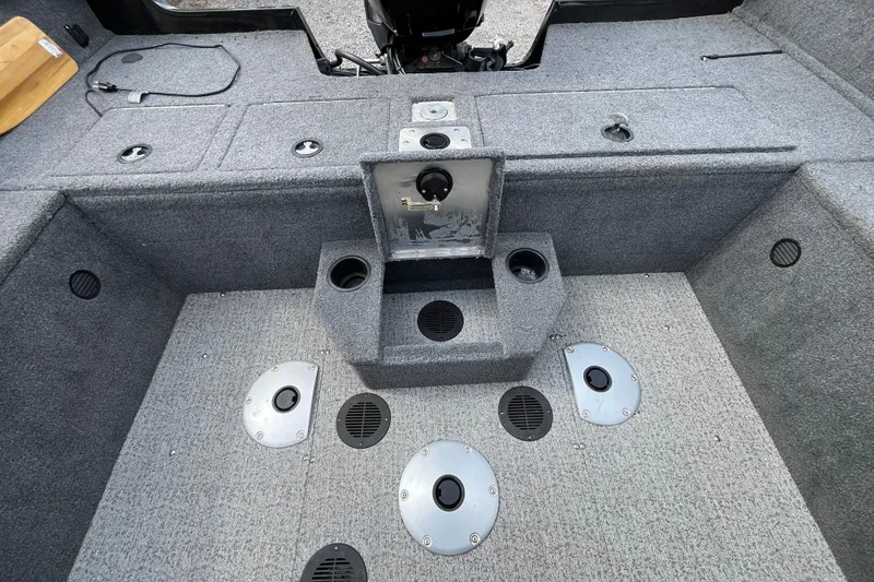 Slide: The Image of 2022 Tracker Pro Guide V-175 WT boat interior with storage compartments and cup holders. - 11