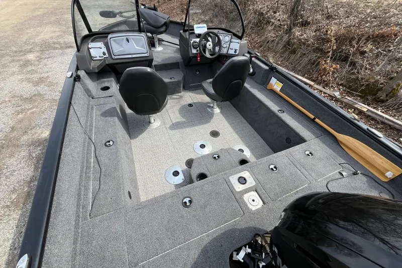 Slide: The Image of 2022 Tracker Pro Guide V-175 WT boat interior with seating and steering console. - 5