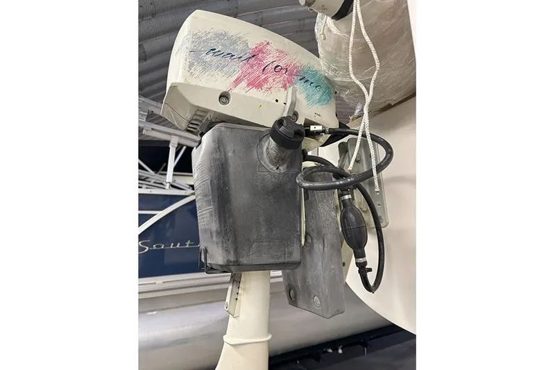 Slide: The Image of Outboard motor attached to a 1988 J Boats J/22 sailboat, showing fuel lines and cables. - 9
