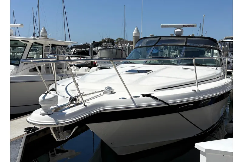 Slide: The Image of 1997 Sea Ray 370 Express Cruiser docked at marina with modern buildings in background. - 14