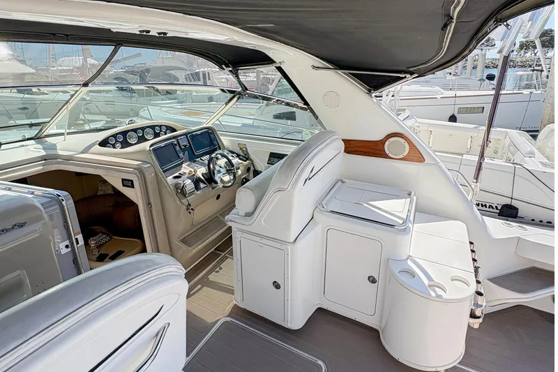 Slide: The Image of 1997 Sea Ray 370 Express Cruiser cockpit with helm, seating, and dashboard controls. - 17