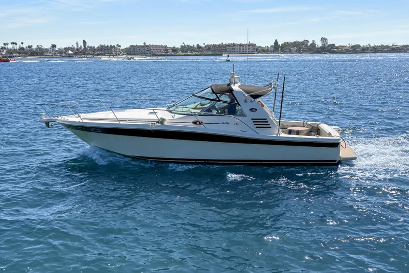Slide: The Image of 1997 Sea Ray 370 Express Cruiser on calm blue water, sunny day. - 2