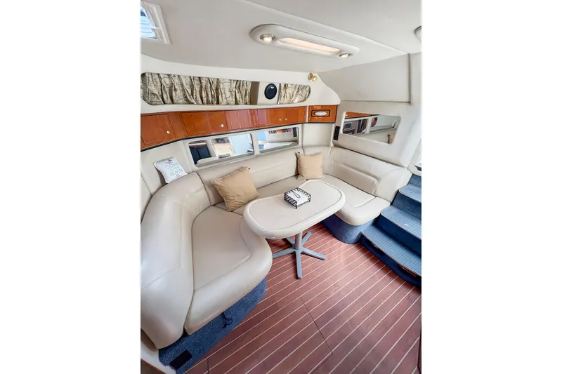 Slide: The Image of Interior of 1997 Sea Ray 370 Express Cruiser with cozy seating and vibrant bedding. - 25