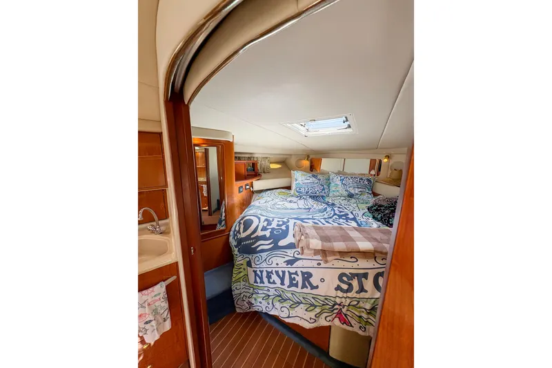 Slide: The Image of 1997 Sea Ray 370 Express Cruiser docked, showcasing sleek white exterior and logo. - 26