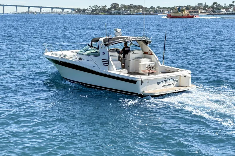Slide: The Image of 1997 Sea Ray 370 Express Cruiser sailing on clear blue waters under a sunny sky. - 4