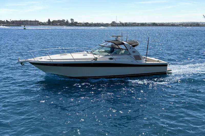 Slide: The Image of 1997 Sea Ray 370 Express Cruiser on calm blue water under clear sky. - 5