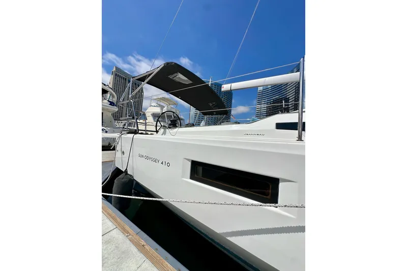 Slide: The Image of 2024 Jeanneau Sun Odyssey 410 sailboat docked under clear blue sky. - 11