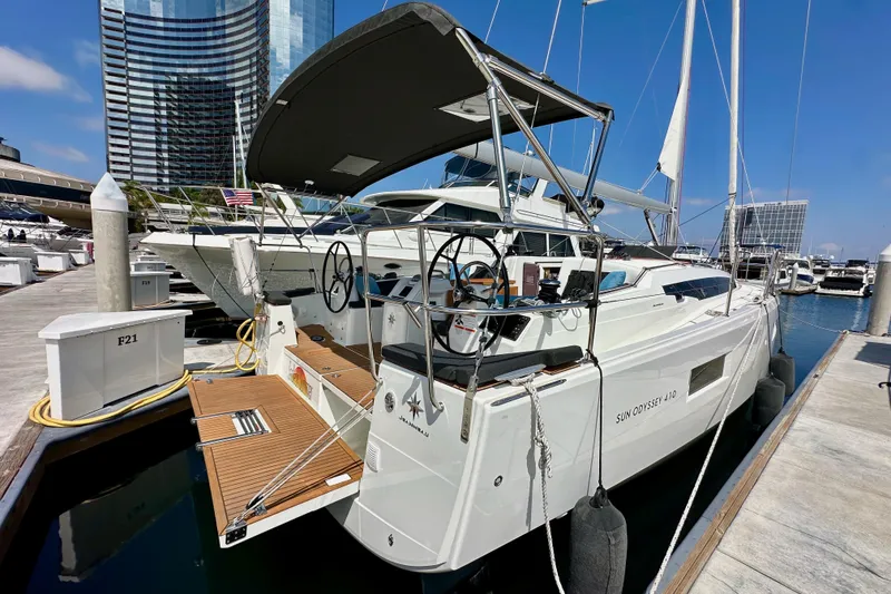 Slide: The Image of 2024 Jeanneau Sun Odyssey 410 yacht docked at a marina, showcasing sleek design and modern features. - 12