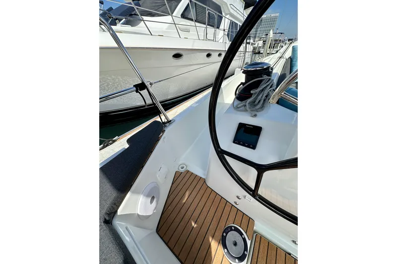 Slide: The Image of 2024 Jeanneau Sun Odyssey 410 cockpit with steering wheel and wooden deck details. - 18