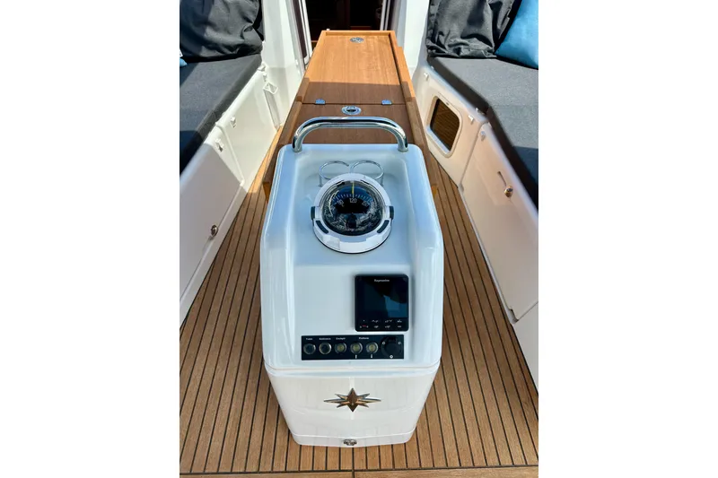 Slide: The Image of 2024 Jeanneau Sun Odyssey 410 cockpit with compass and navigation controls. - 21