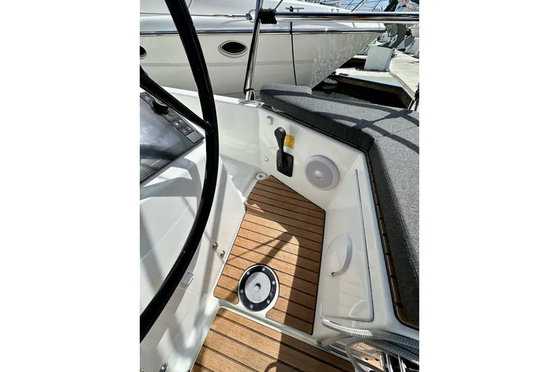 Slide: The Image of 2024 Jeanneau Sun Odyssey 410 cockpit with teak flooring and modern controls. - 25