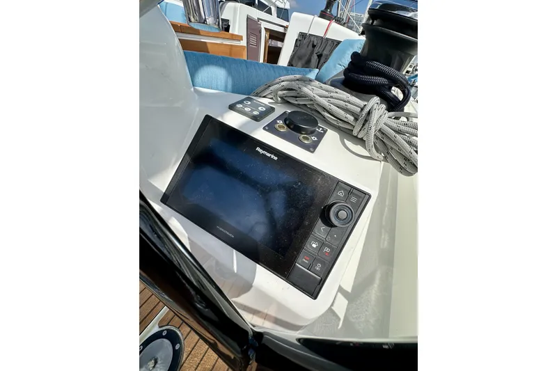 Slide: The Image of 2024 Jeanneau Sun Odyssey 410 cockpit with navigation display and coiled ropes. - 26
