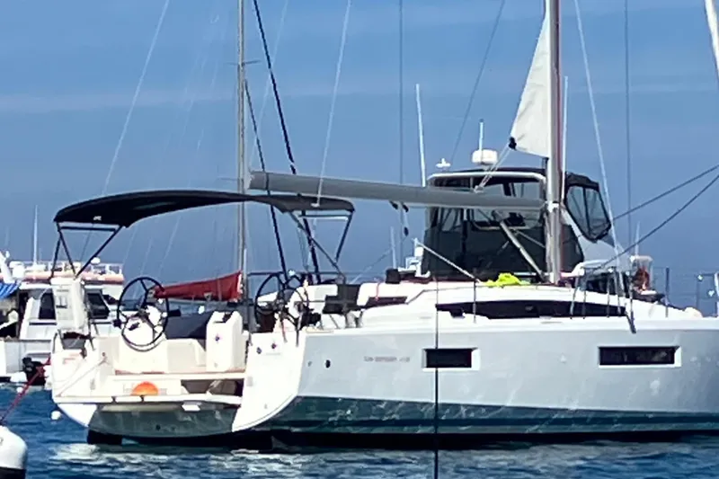 Slide: The Image of 2024 Jeanneau Sun Odyssey 410 sailboat docked in a marina, featuring sleek design and modern amenities. - 3