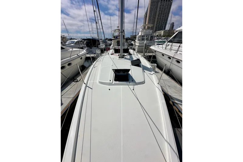Slide: The Image of 2024 Jeanneau Sun Odyssey 410 sailboat docked in a marina, surrounded by other boats. - 37