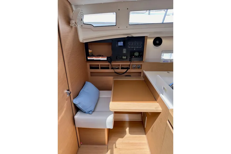 Slide: The Image of Interior of 2024 Jeanneau Sun Odyssey 410 sailboat with navigation station and seating area. - 49