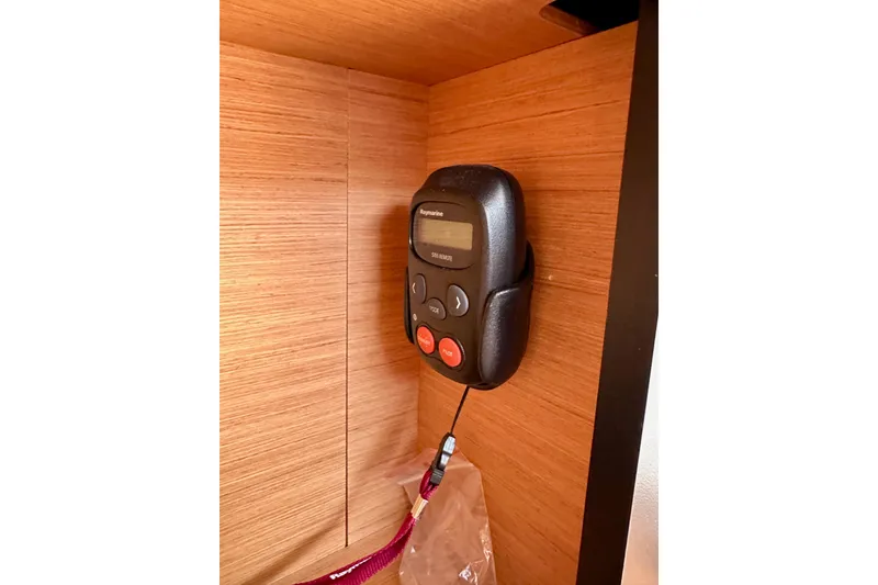 Slide: The Image of Control panel inside 2024 Jeanneau Sun Odyssey 410 yacht, mounted on wooden interior. - 51