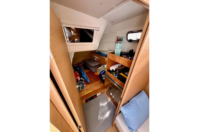 Slide: The Image of Interior cabin of 2024 Jeanneau Sun Odyssey 410 sailboat, featuring storage and seating. - 55