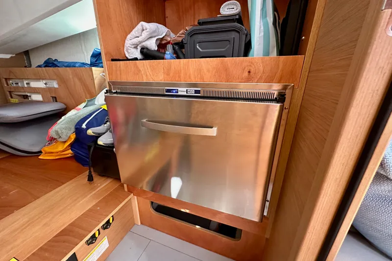 Slide: The Image of Interior of 2024 Jeanneau Sun Odyssey 410 with stainless steel appliance and storage. - 56
