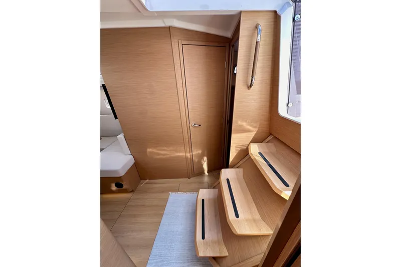 Slide: The Image of Interior of 2024 Jeanneau Sun Odyssey 410, featuring wooden steps and modern design. - 60