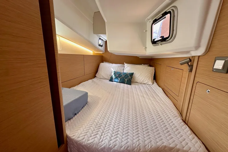 Slide: The Image of 2024 Jeanneau Sun Odyssey 410 cabin interior with cozy bed and modern design. - 62