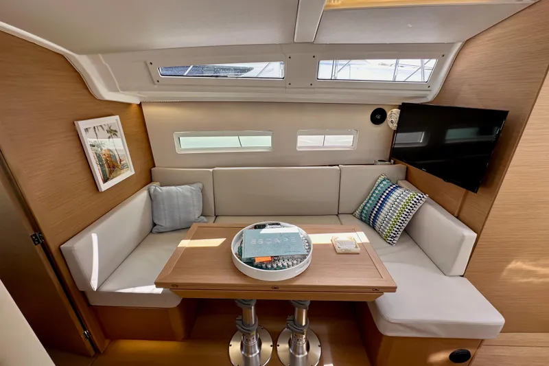 Slide: The Image of 2024 Jeanneau Sun Odyssey 410 interior with cozy seating, table, and modern decor. - 71