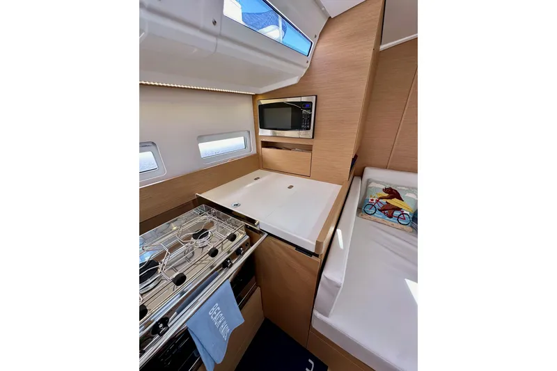 Slide: The Image of 2024 Jeanneau Sun Odyssey 410 interior with modern kitchen and cozy seating area. - 81