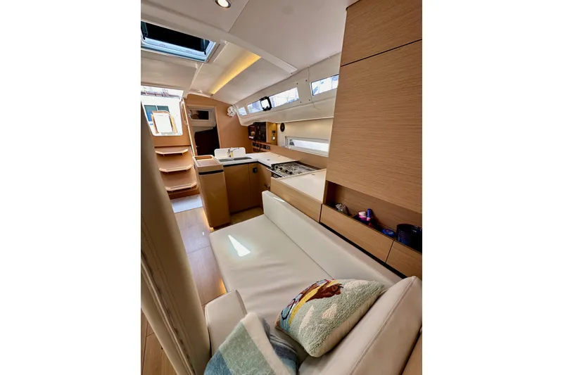 Slide: The Image of Interior of 2024 Jeanneau Sun Odyssey 410 yacht, featuring modern design and cozy seating. - 95