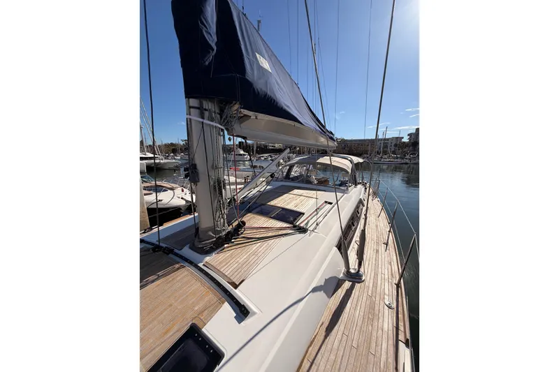 Slide: The Image of Beneteau Oceanis Yacht 60, 2015 model, docked with sails furled, sunny marina view. - 17