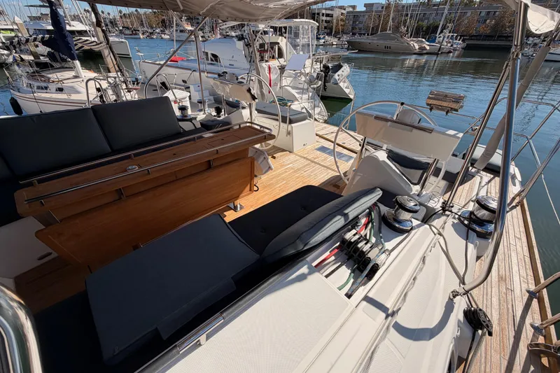 Slide: The Image of Luxurious 2015 Beneteau Oceanis Yacht 60 cockpit with elegant seating and helm, docked in marina. - 19