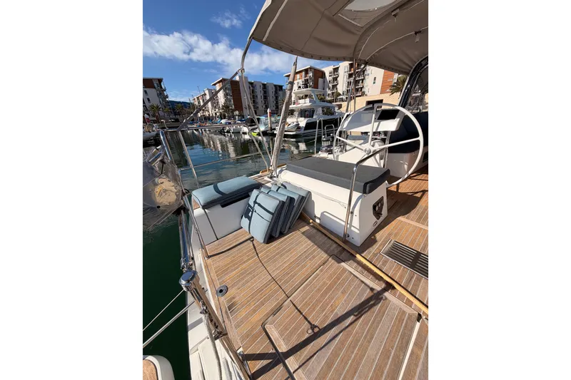 Slide: The Image of Beneteau Oceanis Yacht 60, 2015 model, docked in a marina with clear skies. - 25