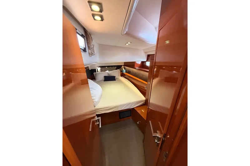 Slide: The Image of Luxurious cabin interior of 2015 Beneteau Oceanis Yacht 60 with cozy bed and wooden finish. - 50