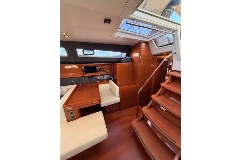 Slide: The Image of Luxurious interior of 2015 Beneteau Oceanis Yacht 60 with wooden finishes and seating area. - 60