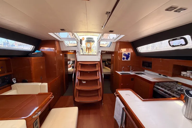 Slide: The Image of Luxurious interior of 2015 Beneteau Oceanis Yacht 60 with modern kitchen and seating area. - 92