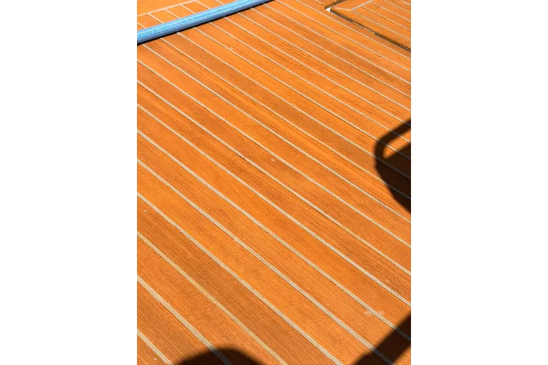 Slide: The Image of Teak deck of 2015 Beneteau Oceanis Yacht 60, showcasing elegant wood finish. - 98
