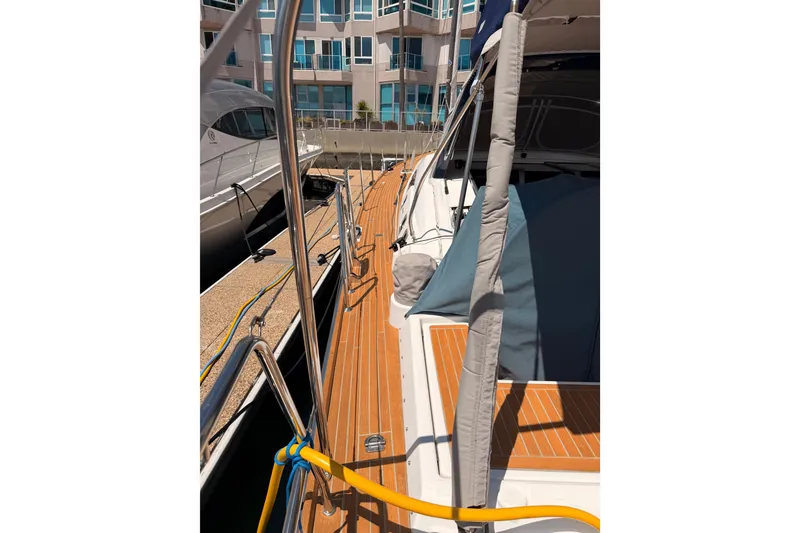 Slide: The Image of Beneteau Oceanis Yacht 60, 2015 model, docked with wooden deck and marina view. - 99