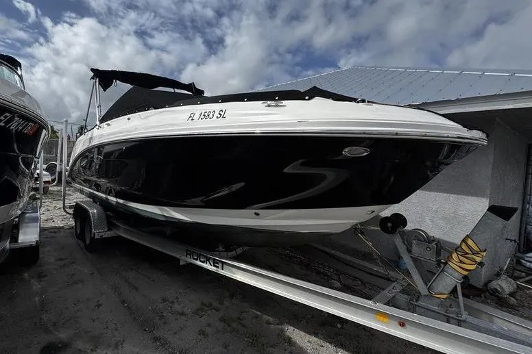 The Image of 2019 Sea Ray SDX 250 boat on trailer under cloudy sky. - 0