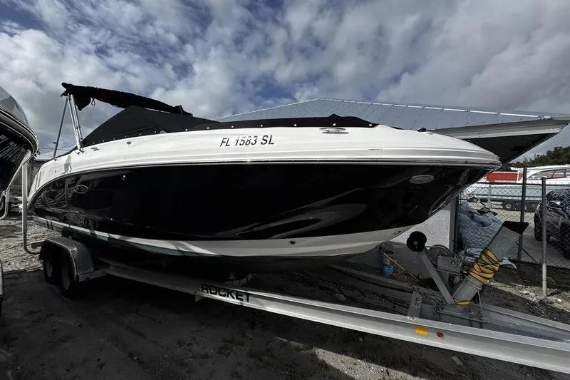 Slide: The Image of 2019 Sea Ray SDX 250 boat on trailer under cloudy sky. - 1
