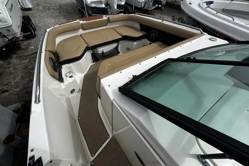 Slide: The Image of 2019 Sea Ray SDX 250 boat interior with beige seating and spacious layout. - 10