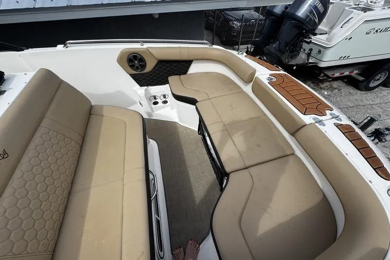 Slide: The Image of Interior view of 2019 Sea Ray SDX 250 boat with beige seating and speaker. - 11