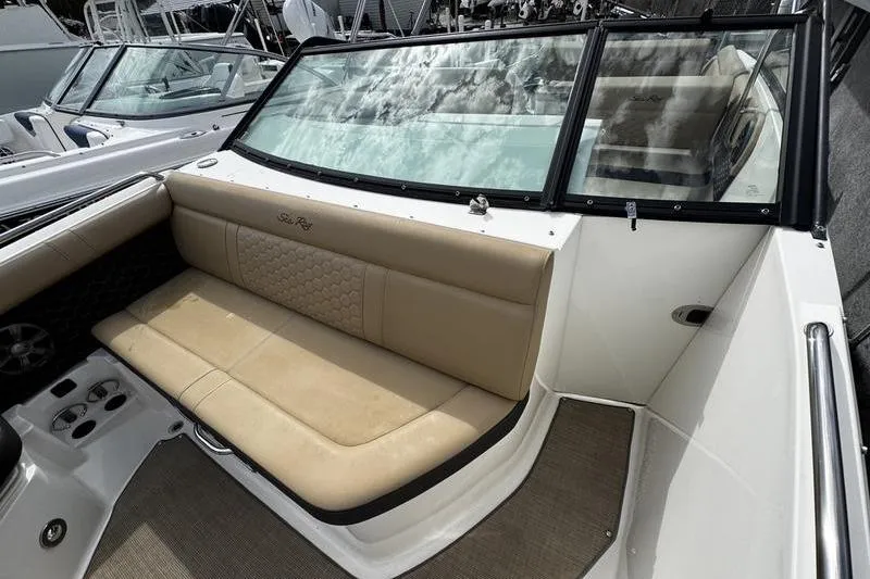 Slide: The Image of 2019 Sea Ray SDX 250 boat interior with beige seating and windshield. - 13